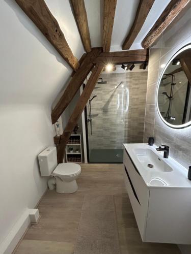 a bathroom with a white sink and a toilet at La Gentilhommière in Rogerville