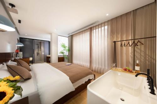 a bedroom with a large bed and a bath tub at Shangri La cuckoo hotel in Shangri-La