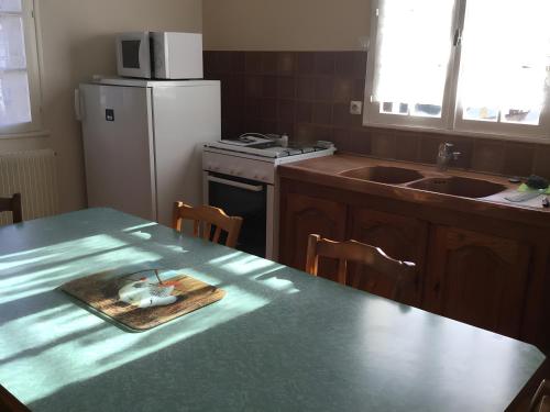 a kitchen with a table with a plate of food on it at Maison Vallée du Loir in Saint-Rimay