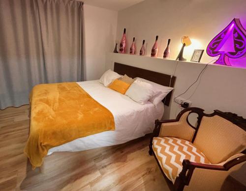 a bedroom with a bed and a chair at Camins del Priorat Ermita sant Pau in Masroig
