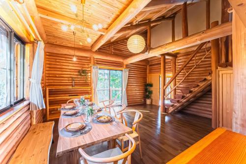 ein Esszimmer aus Holz mit Tisch und Stühlen in der Unterkunft 日本文化に触れる日光リゾート貸切Villa 最大10名 プライベートサウナ 雨でもBBQ にぎわいOK 完全プライベート空間 in Ochikawa