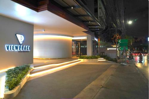 a building with a sign on the side of it at View Place Hotel & Residence Lat Phrao 130 in Bangkok