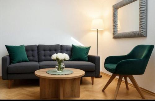 a living room with a couch and a table at ZARA apartment- Near the Old town , 3 ACs , Free Parking, Peaceful in Mostar