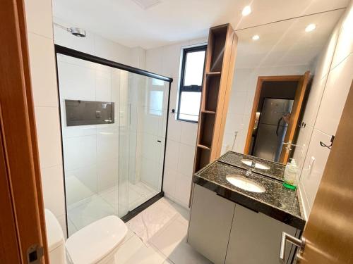 a bathroom with a shower and a toilet and a sink at MALIA BEACH - Alto Padrão - PRAIA MURO ALTO - Porto de Galinhas in Porto De Galinhas