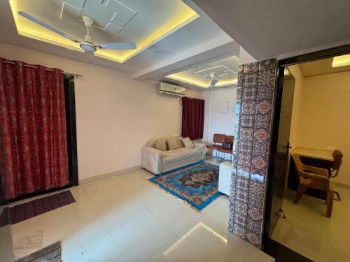 a living room with a couch and a table at Friends Apartment in Raipur