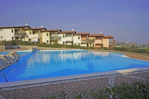 a large blue swimming pool in front of some houses at Blu Garda View in Polpenazze del Garda