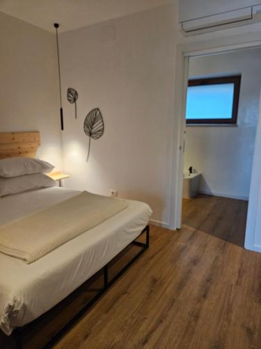 a bedroom with a bed and a window at Dolcevita guest house in Torreano
