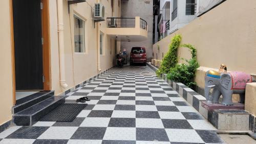 a cat laying on a checkered floor in a alley at Samriddhi Homestay in Varanasi