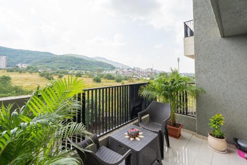 a balcony with chairs and a table with a view at VibeStayZ Bhima Talegaon in Wadgaon