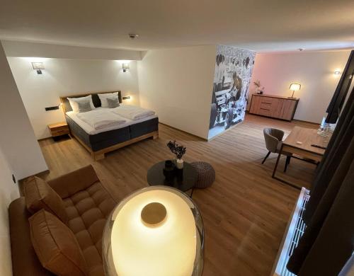a bedroom with a bed and a living room at Hotel Motodrom in Hockenheim