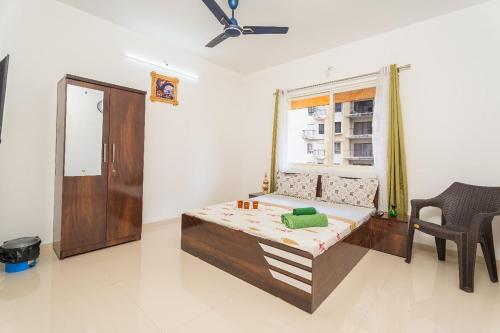 a room with a bed and a window at VibeStayZ Bhima Talegaon in Wadgaon