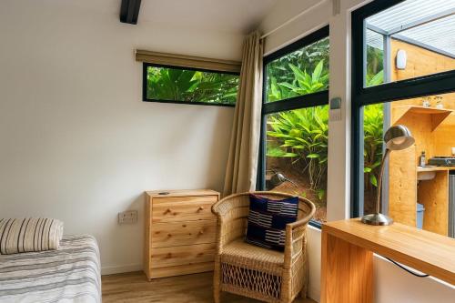 een kamer met een bed, een bureau en een raam bij Nairobi Botanical Retreat - Container Home in Nairobi
