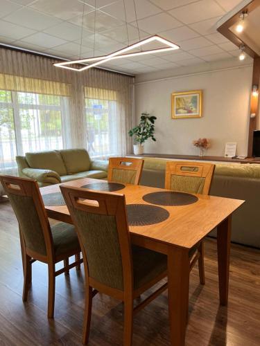 a room with a table and chairs and a couch at RIGA street Apartment 54 entire house in Valmiera