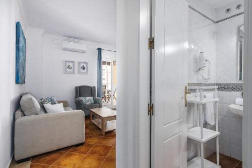 a living room with a couch and a bathroom at Playa Grande - Playa Punta del Moral PPHG150P104 in Isla del Moral