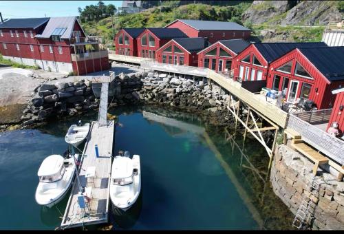 a group of boats docked in a harbor with red buildings at KB Fisherman Cabin - NR3 - Stamsund in Stamsund
