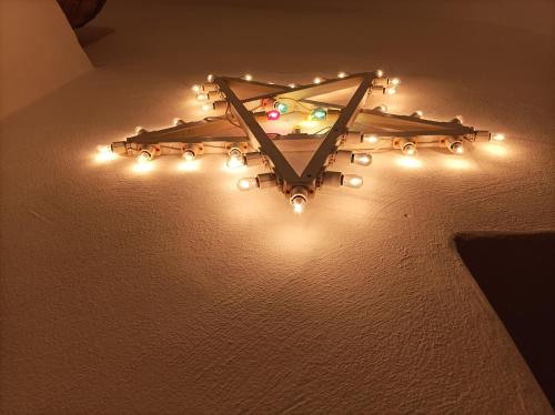a chandelier with lights on a wall at Mèna Mè - Casa vacanza - Salento in Parabita