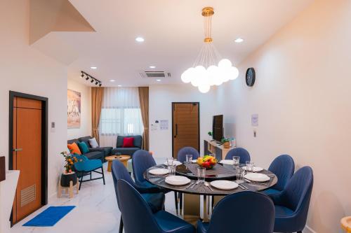 a dining room with a table and blue chairs at EXCLUSIVE SUKHUMVIT RESIDENCE, 3 Min BTS, Thonglor, 20 Guests in Bangkok