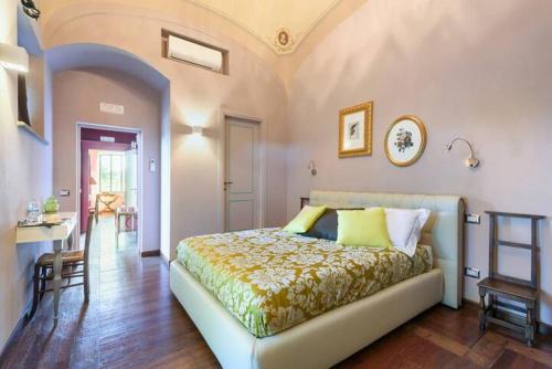 a bedroom with a bed and a table in it at Relais Montemaggiore in Bettolle