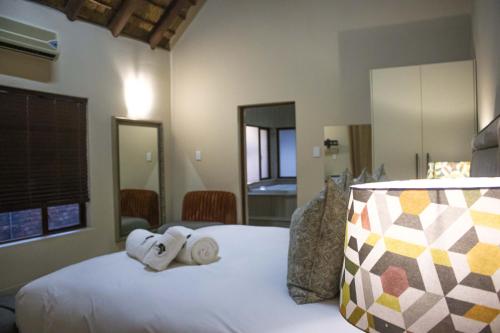 a bedroom with a bed with towels on it at Keleo Safari Lodge in Bela-Bela