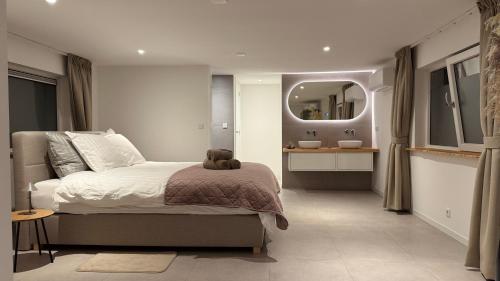 a bedroom with a bed with a teddy bear on it at B&B Ztrand in Oudesluis