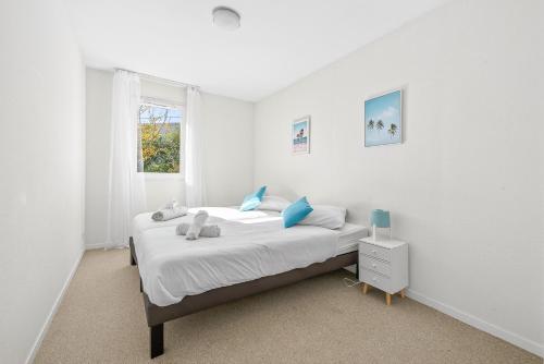 a white bedroom with a bed and a window at Nova - Piscine - Climatisé - Proche Aix-en-Provence in Fuveau