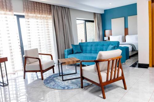 a living room with a blue couch and chairs at Lifestyle Boutique Hotel in Lilongwe