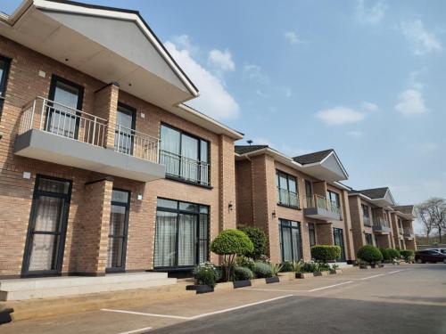 a row of apartment buildings with balconies on a street at Lifestyle Boutique Hotel in Lilongwe