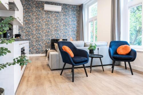 a living room with two chairs and a couch at Spacious Apartment in Tilburg Bed and Coffe in Tilburg