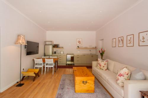 a living room with a couch and a table at Minserie Collection in Stellenbosch