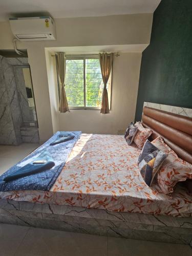 a large bed in a room with a window at StayGinie Baner in Pune