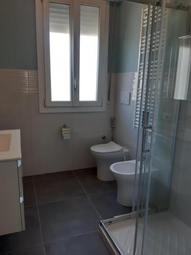 a bathroom with a toilet and a glass shower at Casa Patavina in Padova