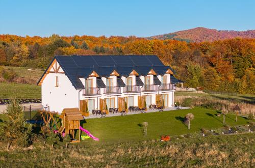 - une vue aérienne sur une maison dotée d'un toit solaire dans l'établissement Bieszczadzkie Siedlisko Apartamenty i noclegi nad Jeziorem Solińskim Myczków blisko Solina i Polańczyk, à Polańczyk
