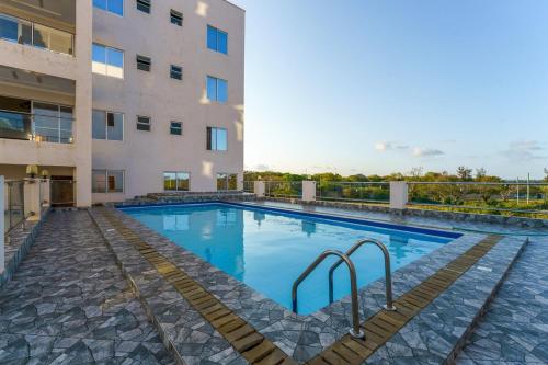 a swimming pool in front of a building at Zuri's Tidehouse, With Beach Access in Mombasa