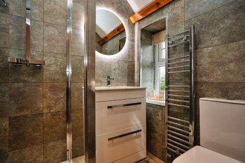 ein Badezimmer mit Waschbecken und Spiegel in der Unterkunft Finest Retreats - The Storehouse in Choppington