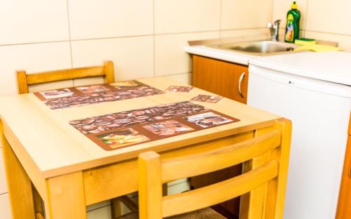 a small kitchen with a table and a sink at Apartmani Kastel in Banja Luka