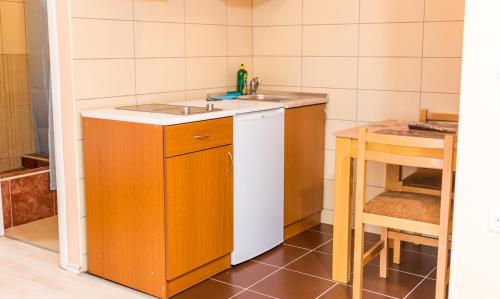 a small kitchen with a sink and a table at Apartmani Kastel in Banja Luka