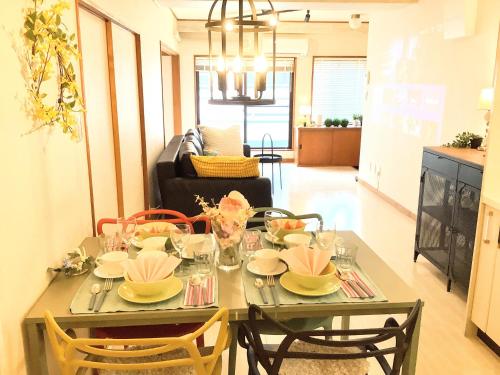 a dining room table with plates and bowls on it at Deep湘南 in Kugenuma