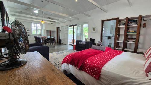 a bedroom with a bed with a red blanket at 40 on Longmarket in Stanford