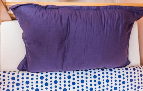 a purple pillow sitting on top of a couch at Apartmani Kastel in Banja Luka