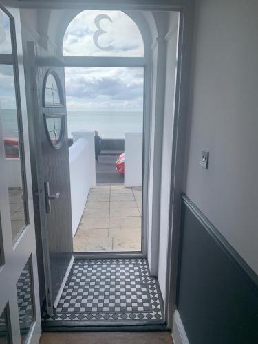 an open door with a view of the ocean at Seafront folkestone Sandgate channel tunnel - 5 star property Sleeps 16 in Sandgate