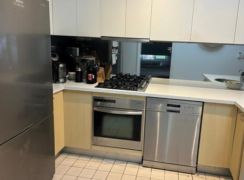 a kitchen with a stove and a stove top oven at Relaxed Coastal Newport Getaway in Newport