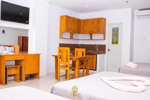 a small room with a desk and a bed and a deskablish at Empress Island Hotel in Alaminos