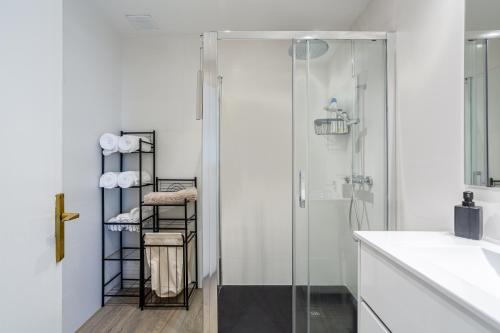 a bathroom with a shower and a glass door at Aubi in Palamós