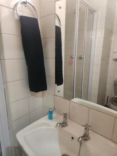 a bathroom with a sink and a mirror at Anique's Guest house in Beaufort West