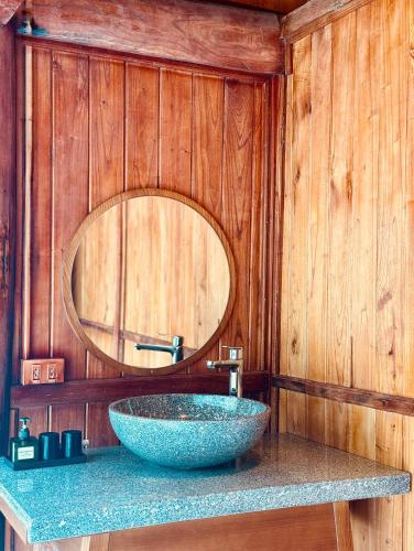 a bathroom with a bowl sink and a mirror at MK Home in Lương Sơn