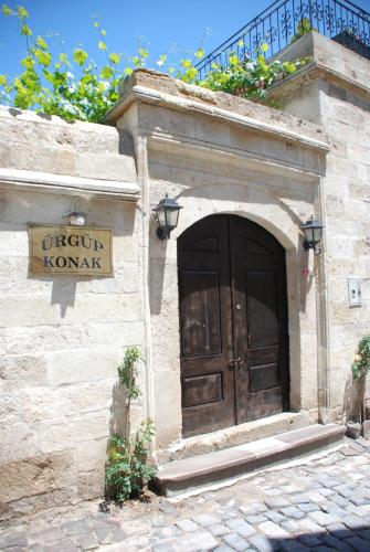 a building with a large wooden door and a sign at Urgup Konak Hotel in Urgup