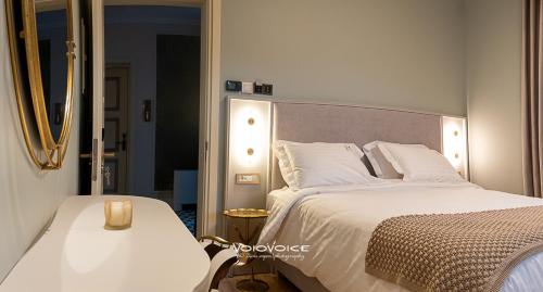 a bedroom with a large bed and a mirror at Megaro Gioule in Siatista