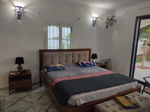 a bedroom with a large bed and a chair at Premium Villa in Ngaparou between Saly Somone in Ngaparou