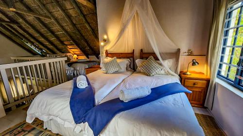 a bedroom with a large bed with a canopy at Lavender’s Blue in Stanford