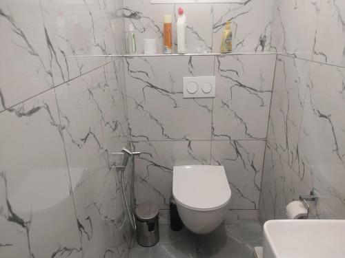 a white bathroom with a toilet and a sink at Premium Villa in Ngaparou between Saly Somone in Ngaparou